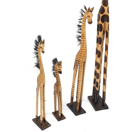 185 - Four wooden giraffes, the largest 150cm high