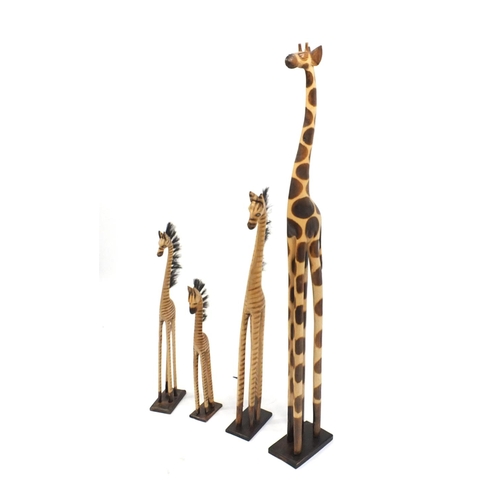 185 - Four wooden giraffes, the largest 150cm high