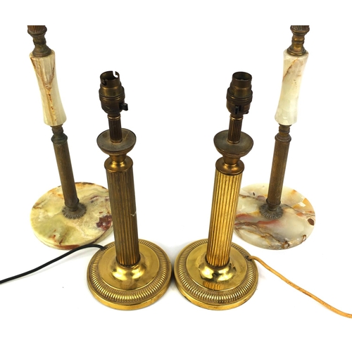 187 - Pair of brass column table lamps and a pair of brass and onyx smokers stands, 68cm high