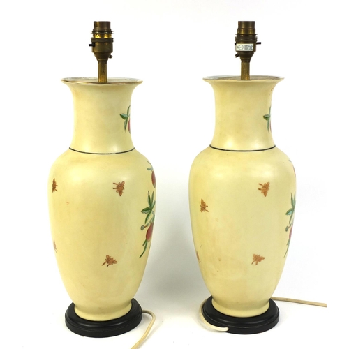 214 - Pair of Oriental porcelain vase tamp lamps decorated with fruiting vines, 46cm high