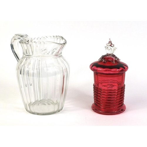 529 - Victorian Cranberry glass cylindrical jar and cover and a Victorian cut glass water jug, 18cm high