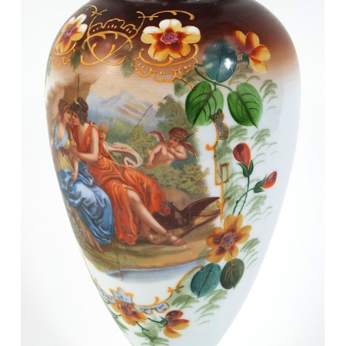 523 - Victorian glass vase decorated with a courting couple and cupid, 35cm high