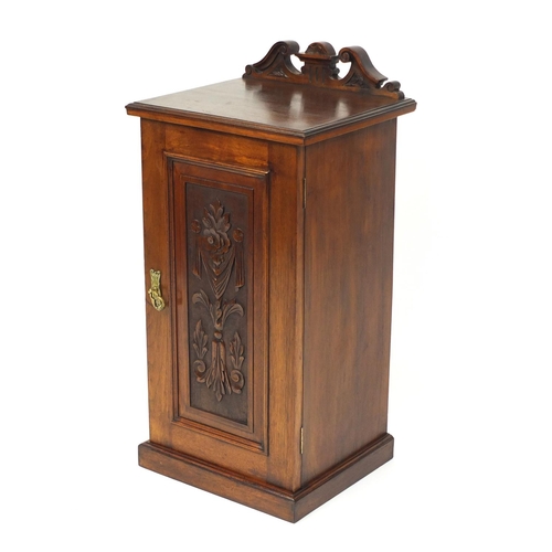 4 - Victorian walnut pot cupboard, the panelled door carved with flowers and swags, 80cm high x 40cm wid... 