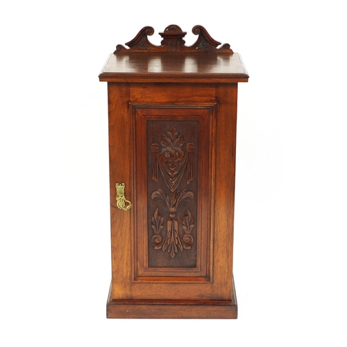 4 - Victorian walnut pot cupboard, the panelled door carved with flowers and swags, 80cm high x 40cm wid... 