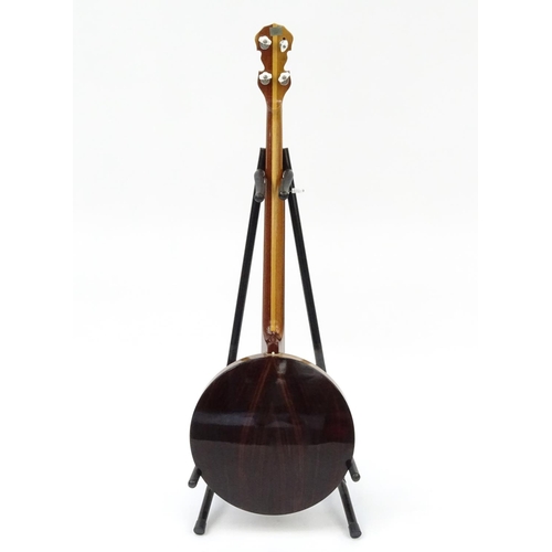 2175 - Mother of Pearl inlaid banjo with rosewood back and protective case, 98cm in length