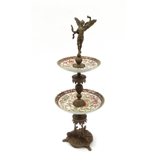 2049 - Bronzed and ceramic two tier centre piece modelled as a winging figure, with stylised column and bas... 