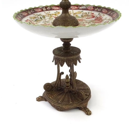 2049 - Bronzed and ceramic two tier centre piece modelled as a winging figure, with stylised column and bas... 