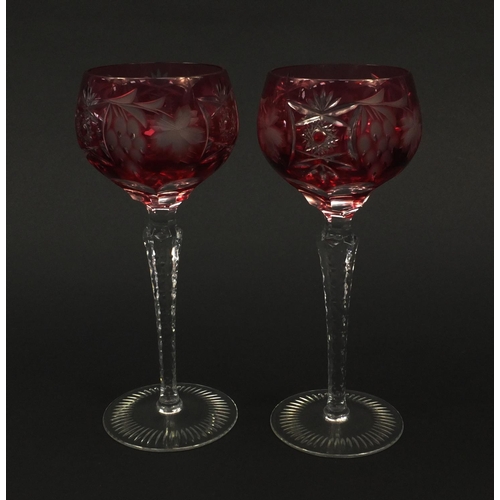 2220 - Pair of cranberry overlaid cut glass vases etched with foliage and berries, each 22cm high