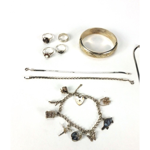 2528 - Silver and white metal jewellery including necklaces, rings, charm bracelet, bangle with floral chas... 