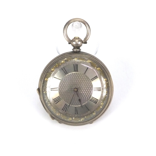 2535 - Ladies silver pocket watch with floral chased decoration and ornate silvered dial, 3.8cm in diameter... 