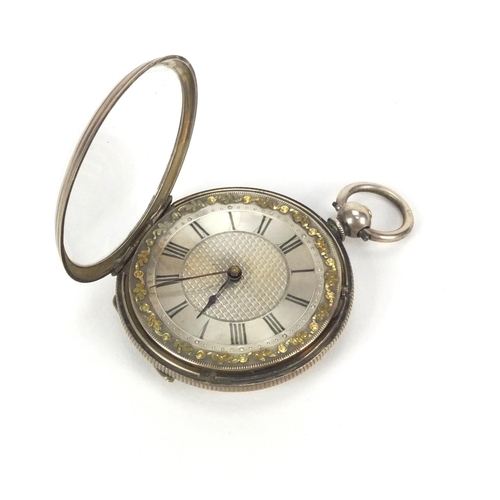 2535 - Ladies silver pocket watch with floral chased decoration and ornate silvered dial, 3.8cm in diameter... 