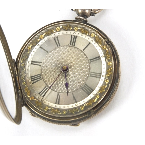 2535 - Ladies silver pocket watch with floral chased decoration and ornate silvered dial, 3.8cm in diameter... 