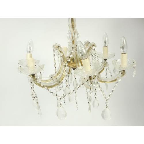 566 - Brass and glass five branch chandelier with glass drops, approximately 55cm in diameter