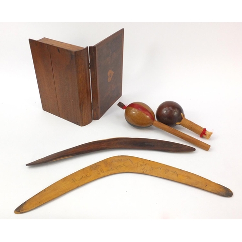 681 - Wooden objects including a jewellery box in the form of a book, boomerangs and maracas