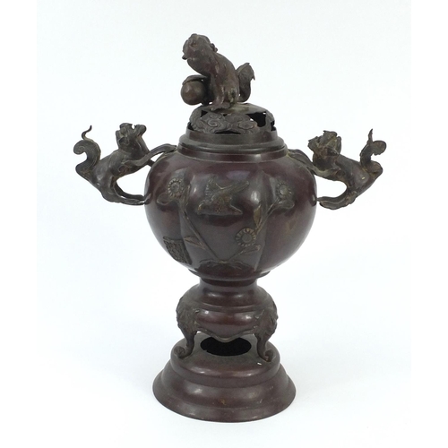 666 - Oriental cast metal koro on stand with Dog of Foo handles and relief decorated with birds on a branc... 