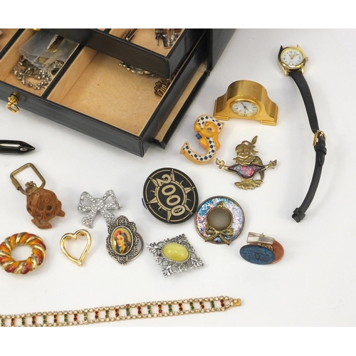 384 - Assorted costume jewellery including earrings, brooches, necklaces etc housed in a black leatherette... 