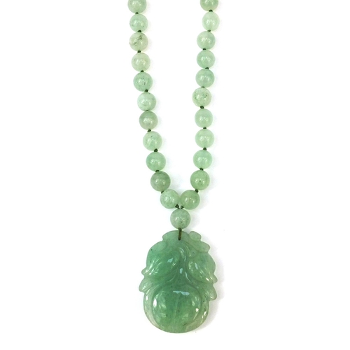 373 - Oriental carved jadeite bead necklace with pendant, 66cm long