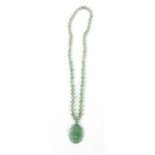 373 - Oriental carved jadeite bead necklace with pendant, 66cm long