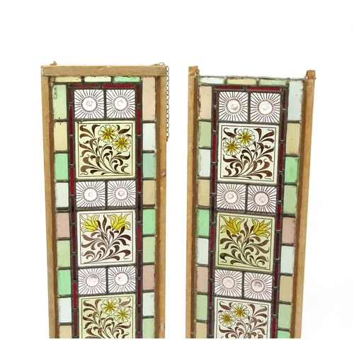 2053 - Pair of leaded stained glass window panels, each with floral panels, each 111cm x 30cm