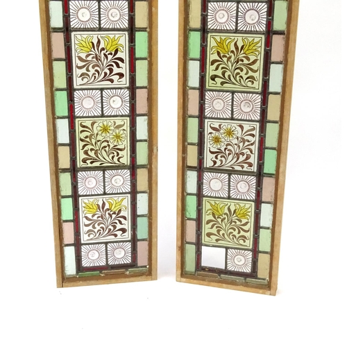 2053 - Pair of leaded stained glass window panels, each with floral panels, each 111cm x 30cm