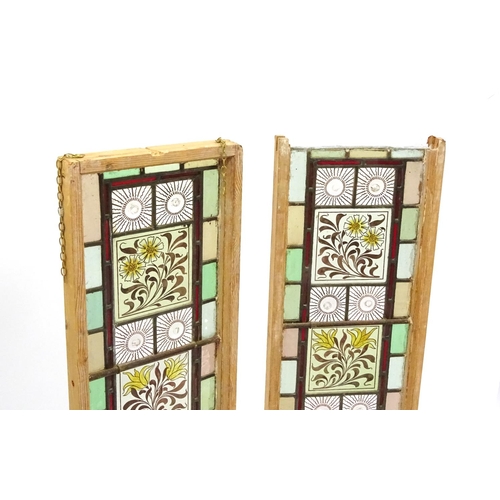 2053 - Pair of leaded stained glass window panels, each with floral panels, each 111cm x 30cm