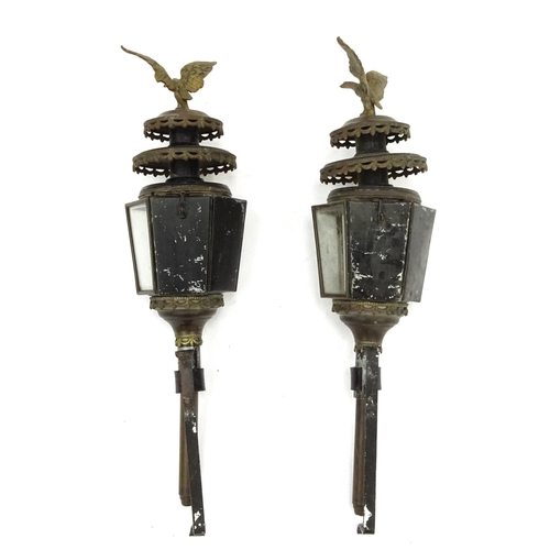 2139 - Pair of metal lanterns with bevelled glass, each mounted with an eagle, each 82cm in length