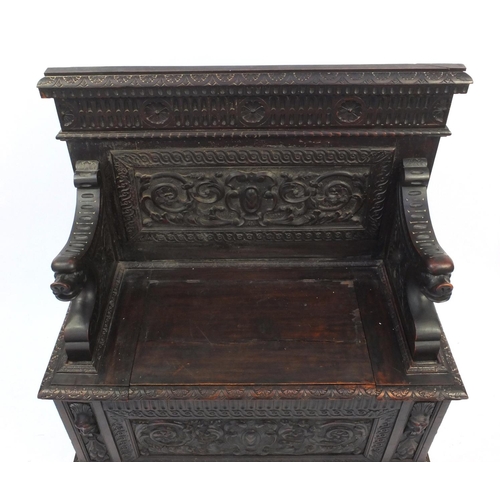 2009 - Profusely carved oak monks bench with lion handles and lift up seat, 112cm high x 105cm wide x 48cm ... 