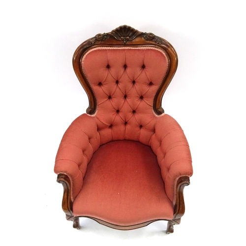 2042 - Victorian style walnut framed reading chair with shell crest and salmon button back upholstery, 103c... 