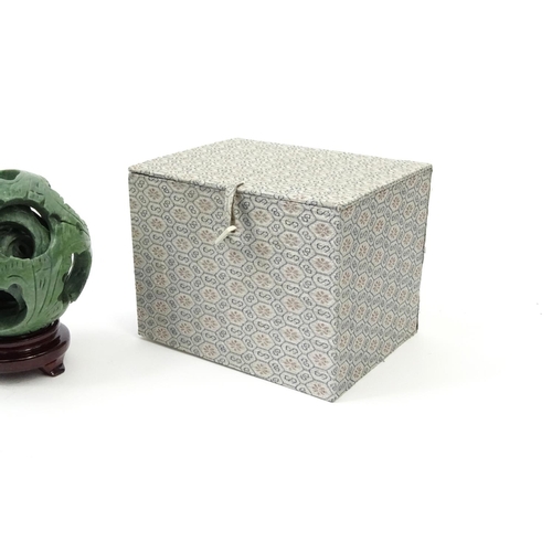 245 - Boxed Oriental carved soapstone puzzle ball raised on a hardwood stand and a soapstone seal set with... 