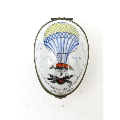 427 - French enamelled porcelain egg trinket, the hinged lid decorated with a hot air balloon, 6cm long