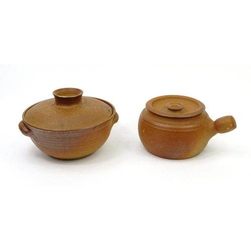 660 - Two Winchcombe pottery cooking pots with covers, the larger 25cm in diameter