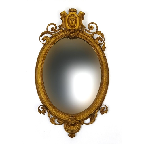 26 - Ornate gilt wood framed oval mirror, 94cm long x 55cm wide