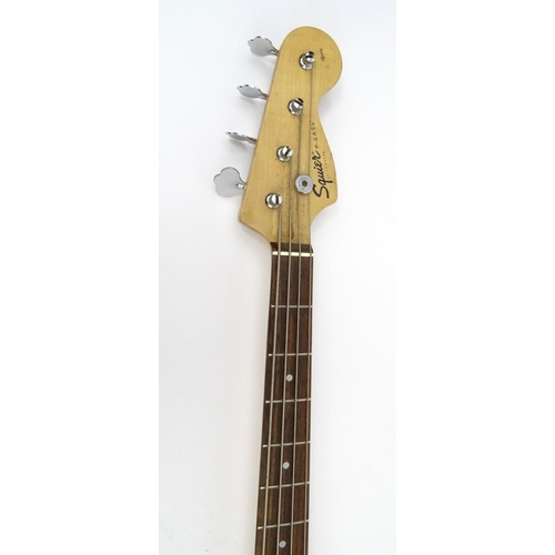 719 - Squire by Fender four string base guitar