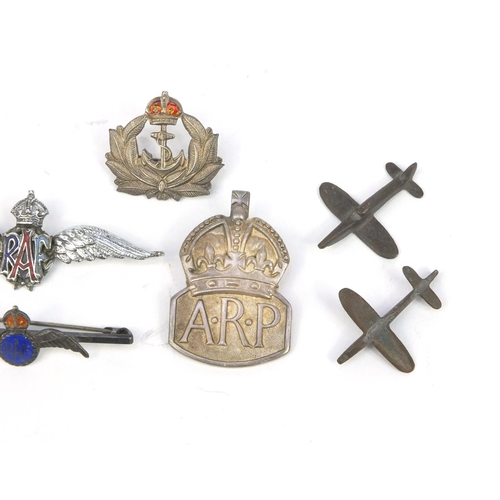 771 - Military interest badges including enamelled RAF example, silver ARP badge, miniature brass Spitfire... 