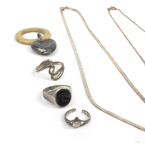 358 - Small selection of silver and white metal jewellery including necklaces and rings, and a silver baby... 