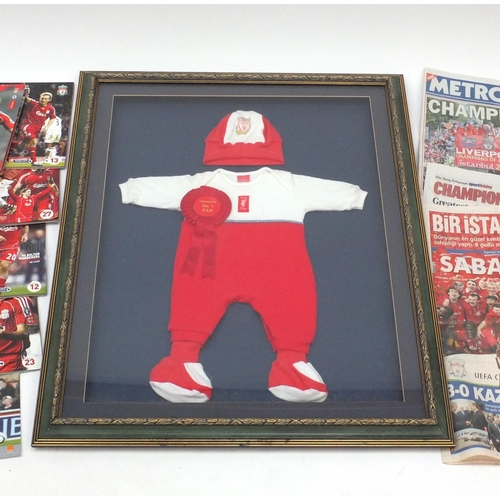 724 - Framed football interest Liverpool babies suit with a collection of Liverpool football programmes