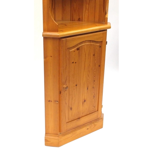 156 - Pine corner cupboard fitted with open shelves above a cupboard base, 178cm high