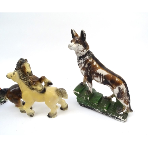 695 - Pair of Art Deco plaster dogs and a horse group, the dogs 42cm high