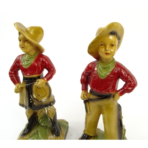 674 - Pair of painted plaster cowboy and cowgirl figures, 33cm high