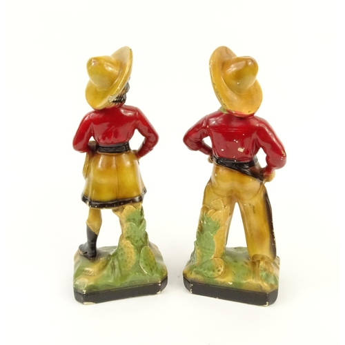 674 - Pair of painted plaster cowboy and cowgirl figures, 33cm high