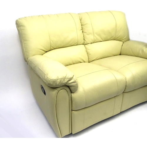 16 - Cream leather reclining two seater settee, 140cm long