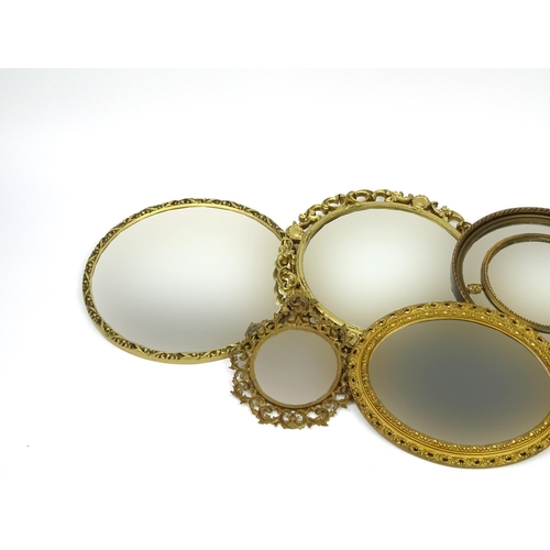 145 - Five circular gilt framed wall hanging mirrors, the largest 56cm in diameter