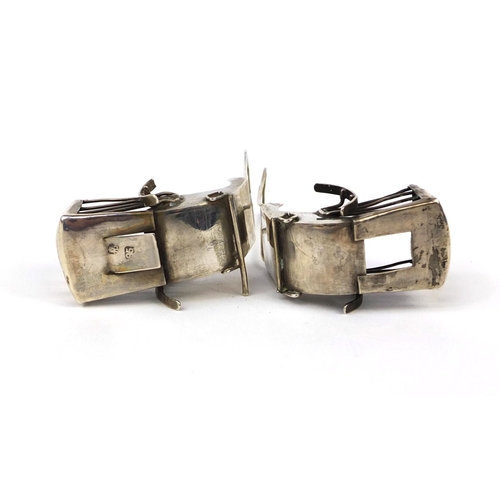 2293 - Two Chinese silver rickshaw one with impressed marks to the reverse, each 8cm in length, approximate... 