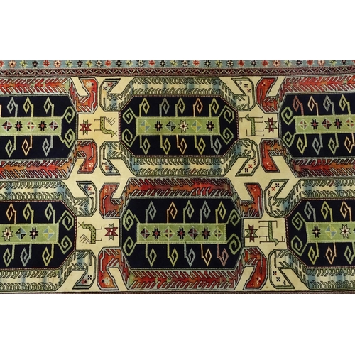 11 - Multi coloured geometric patterned rug, 300cm x 150cm