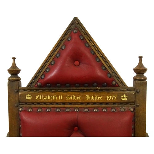 66 - Elizabeth II Silver Jubilee 1977 oak Throne with red leather button back upholstery, 140cm high