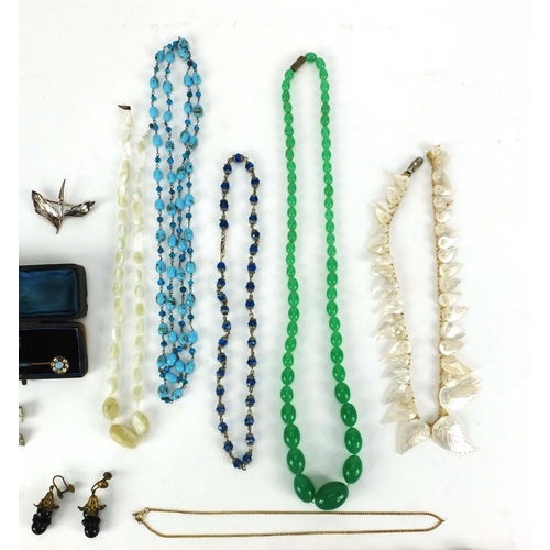 2542 - Assorted jewellery including a silver leaf brooch, glass bead necklaces, animal foot brooches etc