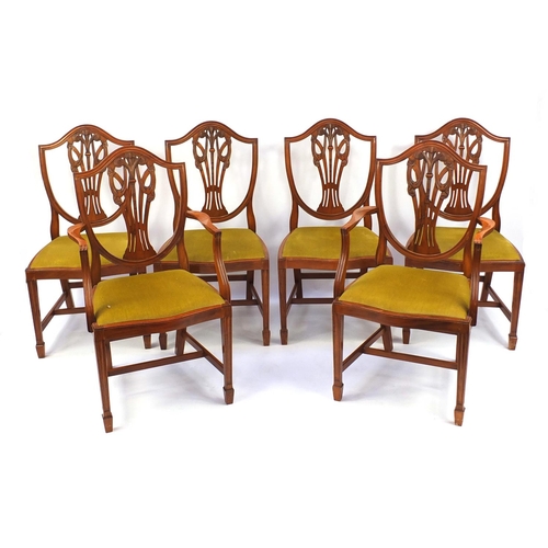 9 - Yew twin pedestal D-end dining and six dining chairs including two carvers, each carved with The Pri... 
