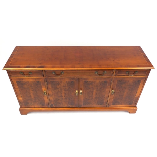 10 - Inlaid yew sideboard fitted with three drawers above four cupboard doors raised on bracket feet, 80c... 