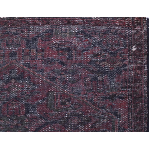15 - Rectangular Hamadan carpet runner with an all over geometric and floral design onto a red ground, 25... 