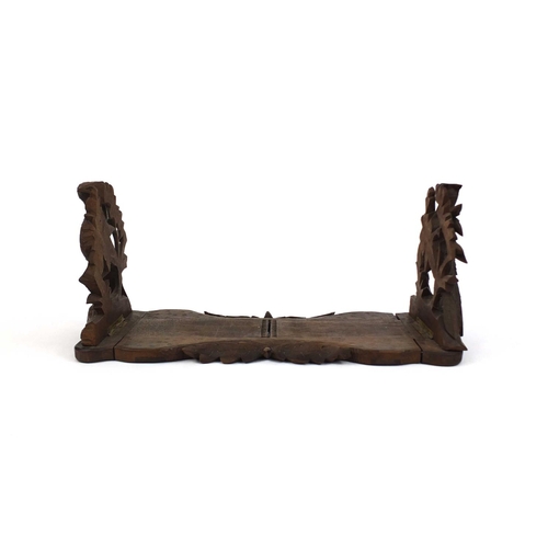 258 - Black forest extending book slide, the fold up ends carved with game, 39cm wide unextended